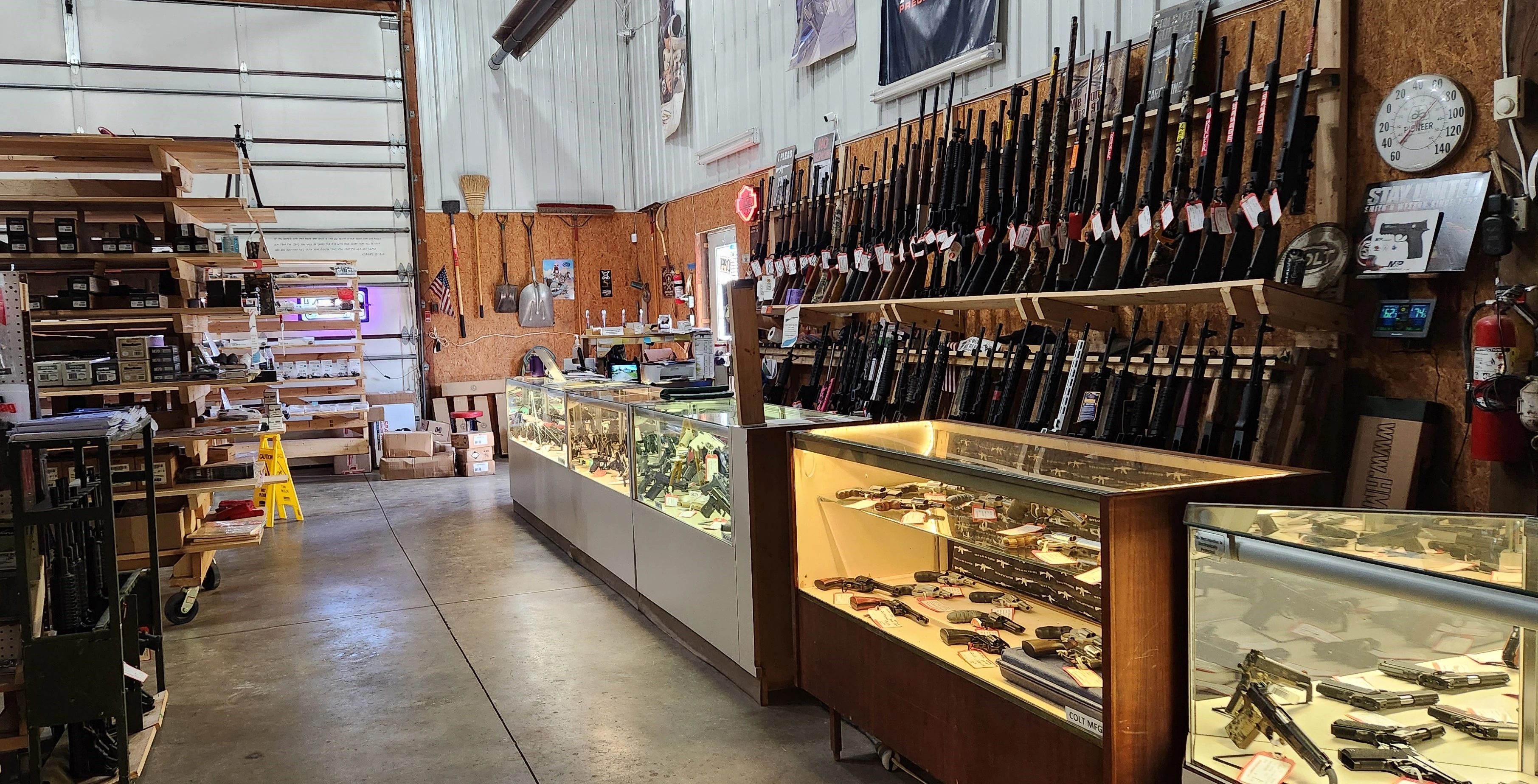 A selection of rifles and shotguns mounted on wall display in Crosshairs Armament LLC.