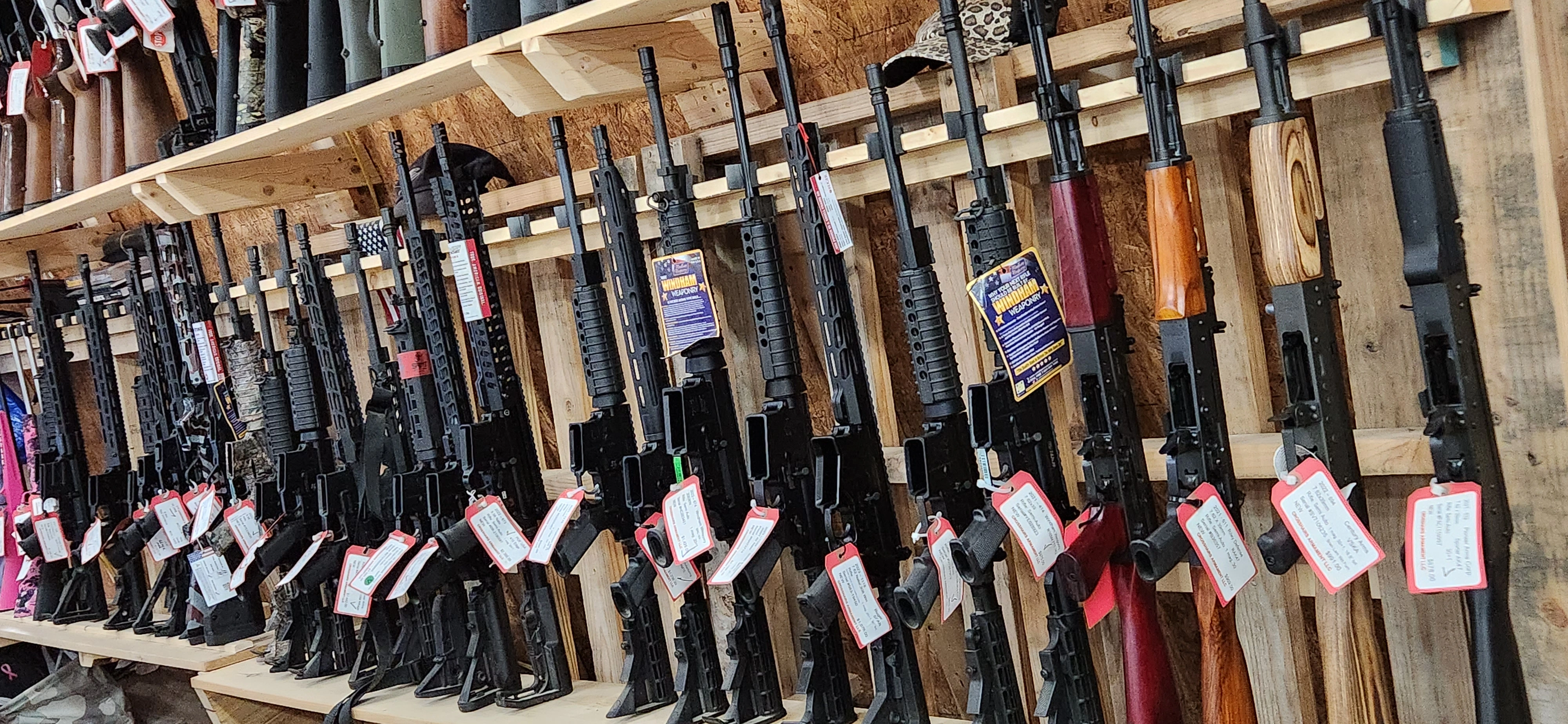 Assorted AR-15's and more displayed on shelves in Crosshairs Armament LLC.