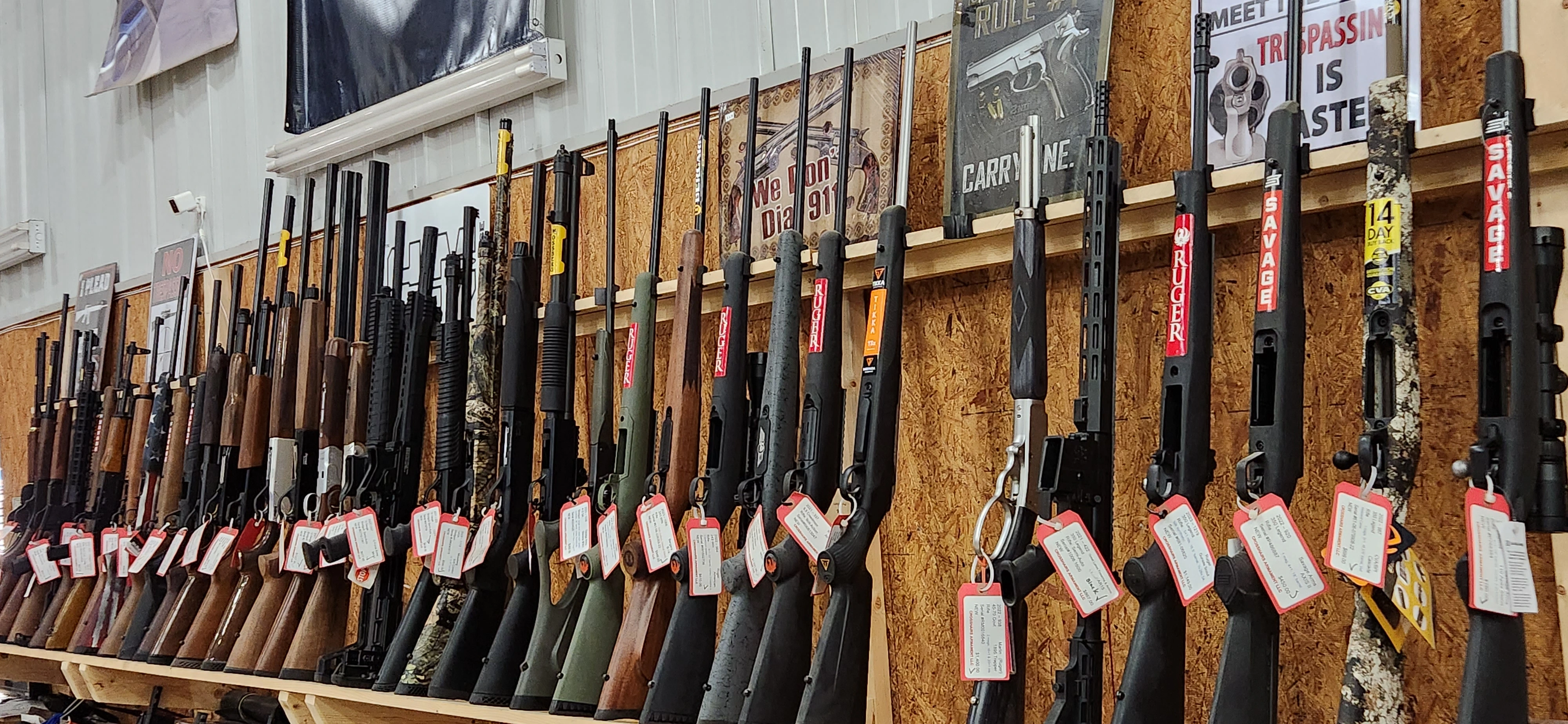 Assorted shotguns and more displayed on shelves in Crosshairs Armament LLC.