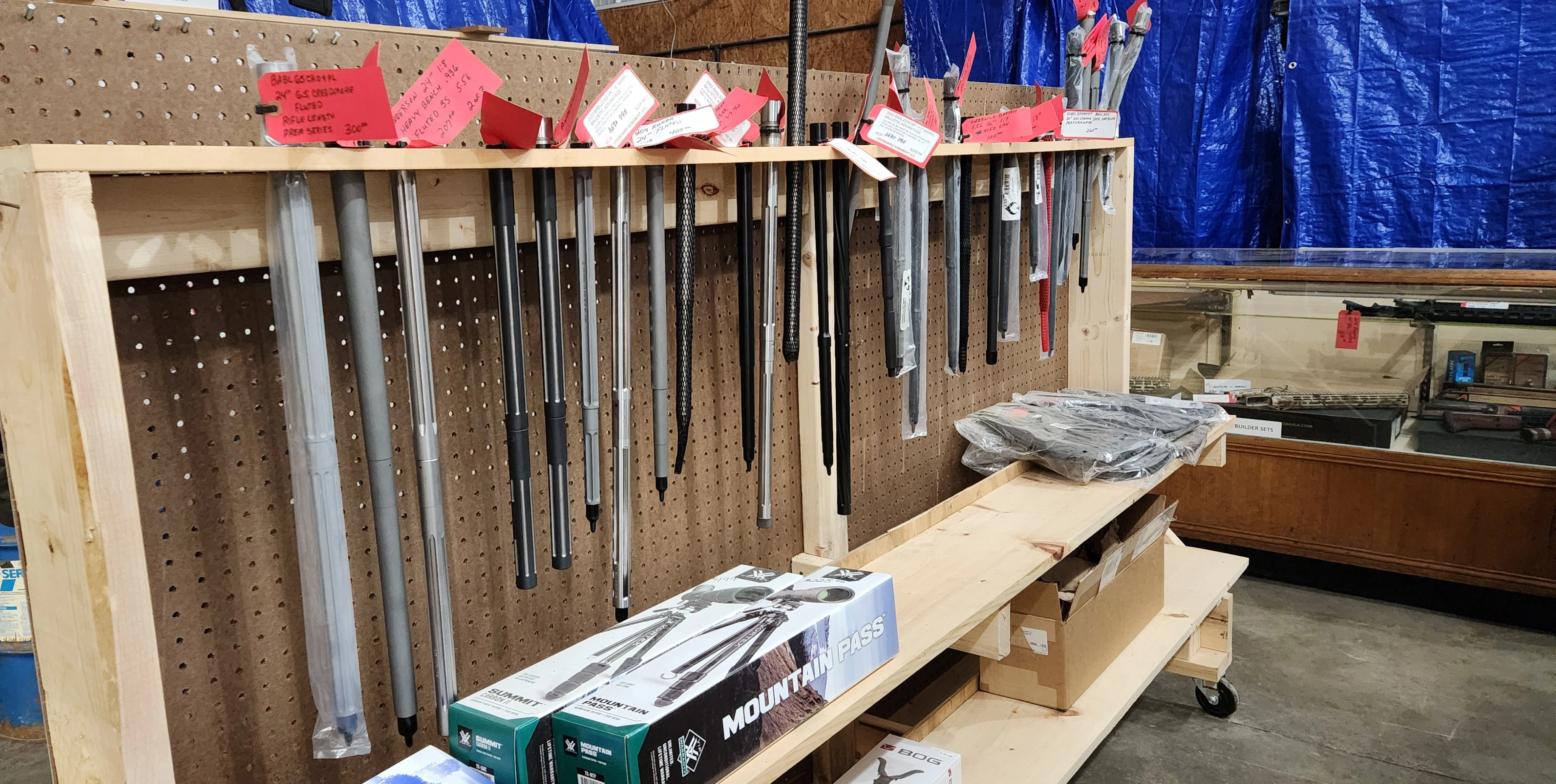 Assorted barrels and more displayed on shelves in Crosshairs Armament LLC.